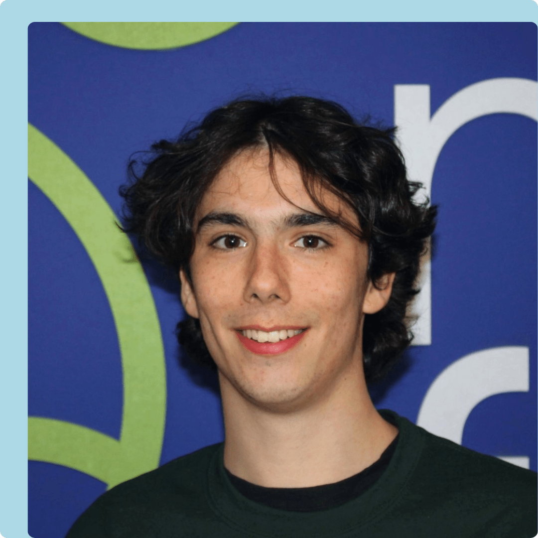 Nick real blue background headshot-min
